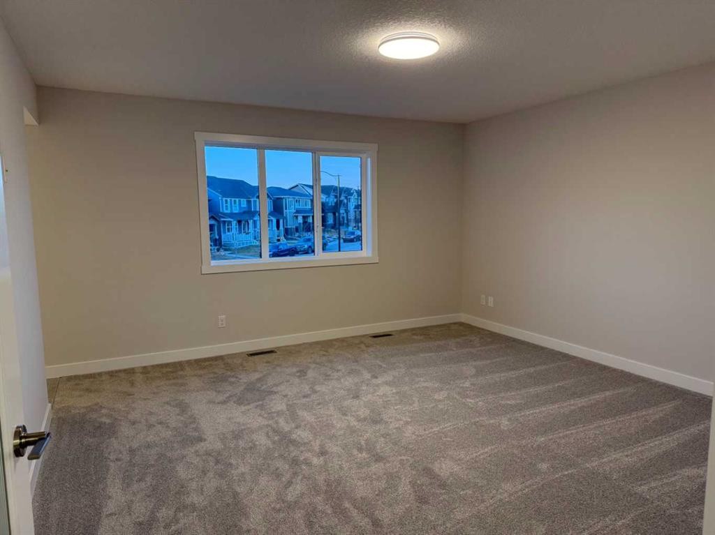 51 Sunrise Heath, Cochrane, AB - Indoor Photo Showing Other Room