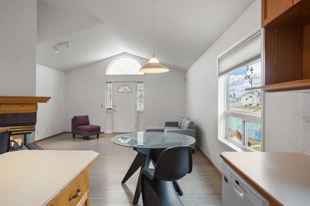 70 Anaheim Green Ne, Calgary, AB - Indoor Photo Showing Dining Room With Fireplace