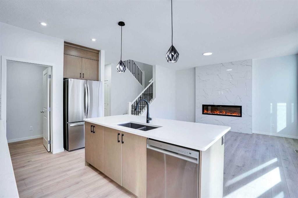 312 Edith Place Nw, Calgary, AB - Indoor Photo Showing Kitchen With Fireplace With Double Sink