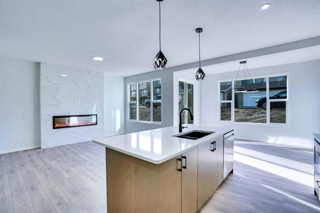 312 Edith Place Nw, Calgary, AB - Indoor Photo Showing Kitchen With Fireplace With Double Sink