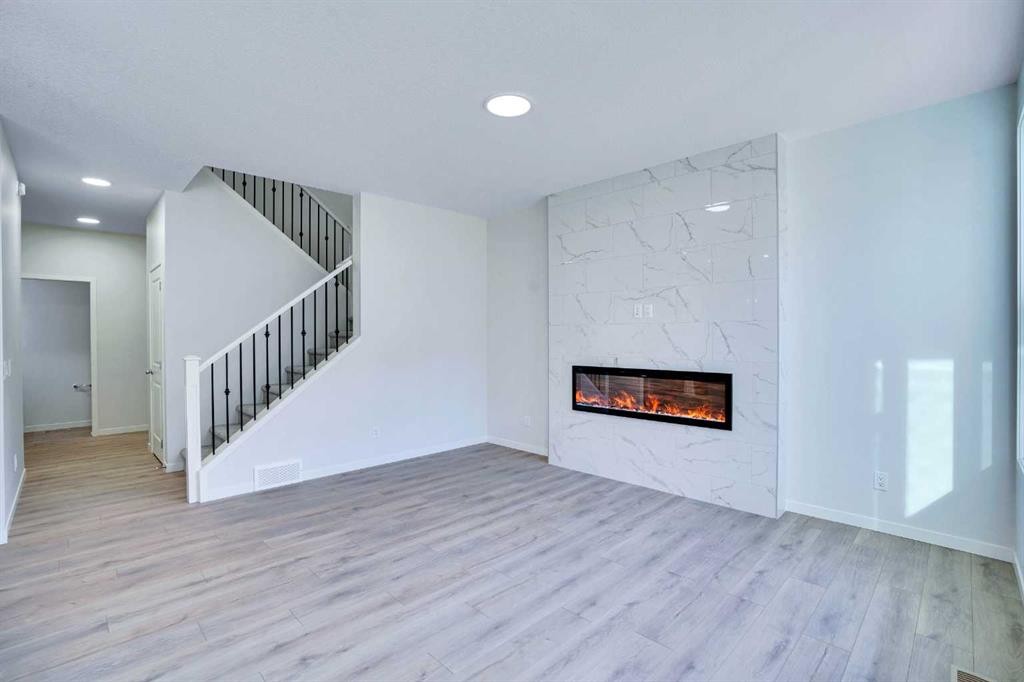 312 Edith Place Nw, Calgary, AB - Indoor Photo Showing Living Room With Fireplace