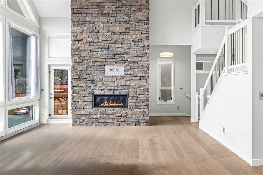 204-105 Stewart Creek Rise Sw, Canmore, AB - Indoor Photo Showing Living Room With Fireplace