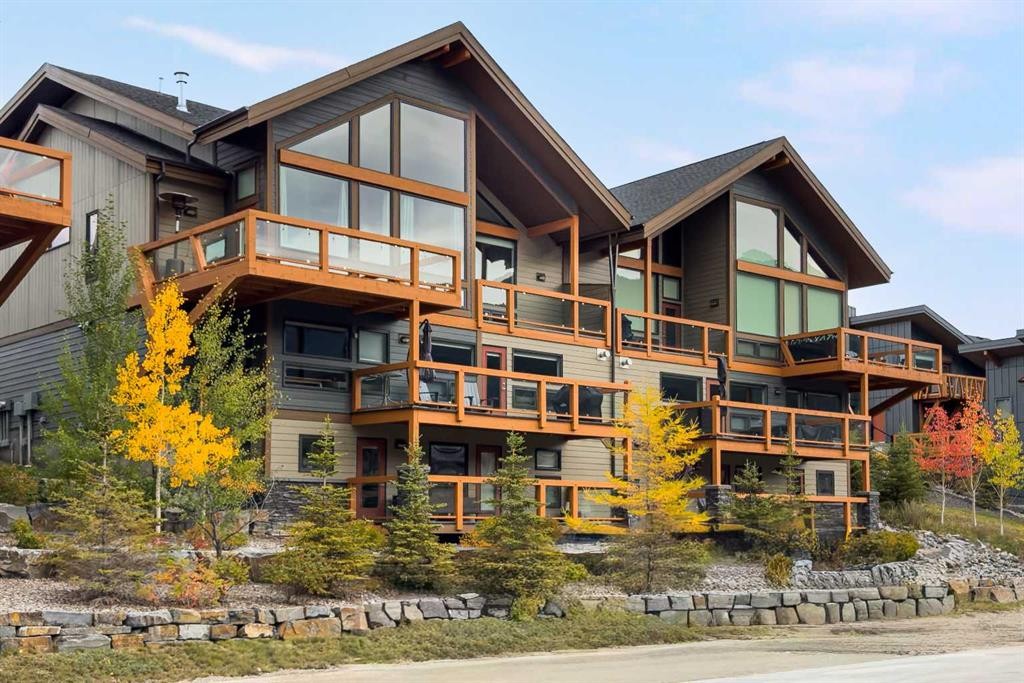 204-105 Stewart Creek Rise Sw, Canmore, AB - Outdoor With Balcony With Facade