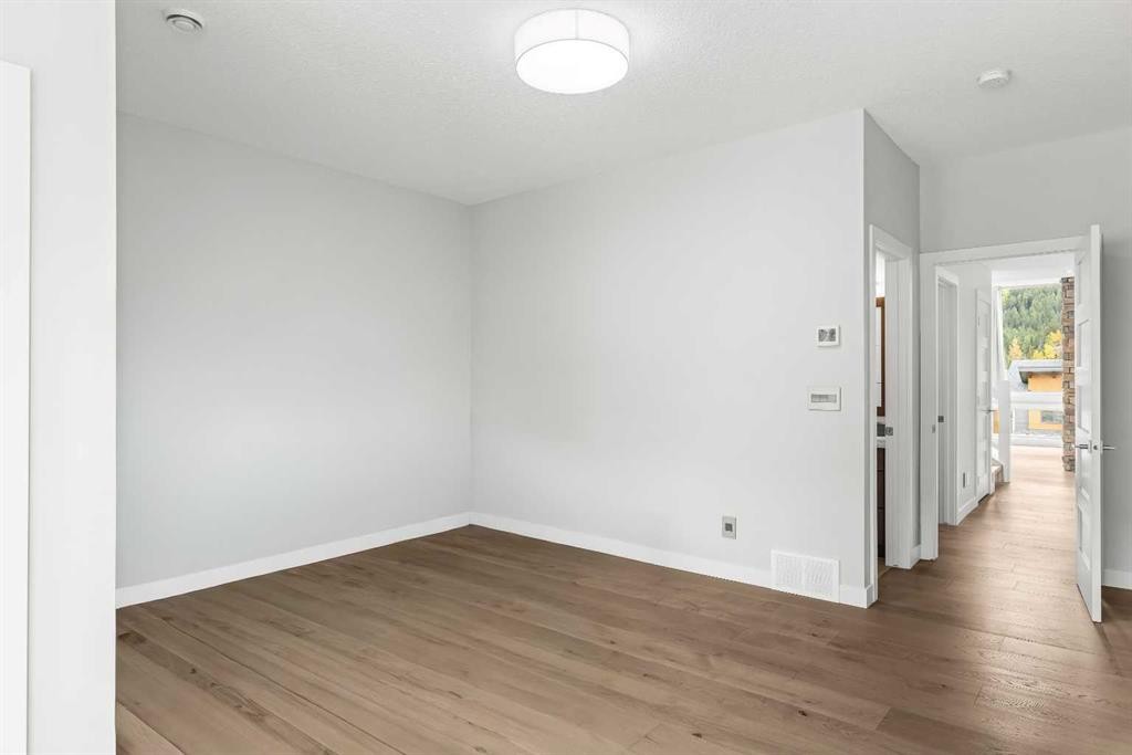 204-105 Stewart Creek Rise Sw, Canmore, AB - Indoor Photo Showing Other Room