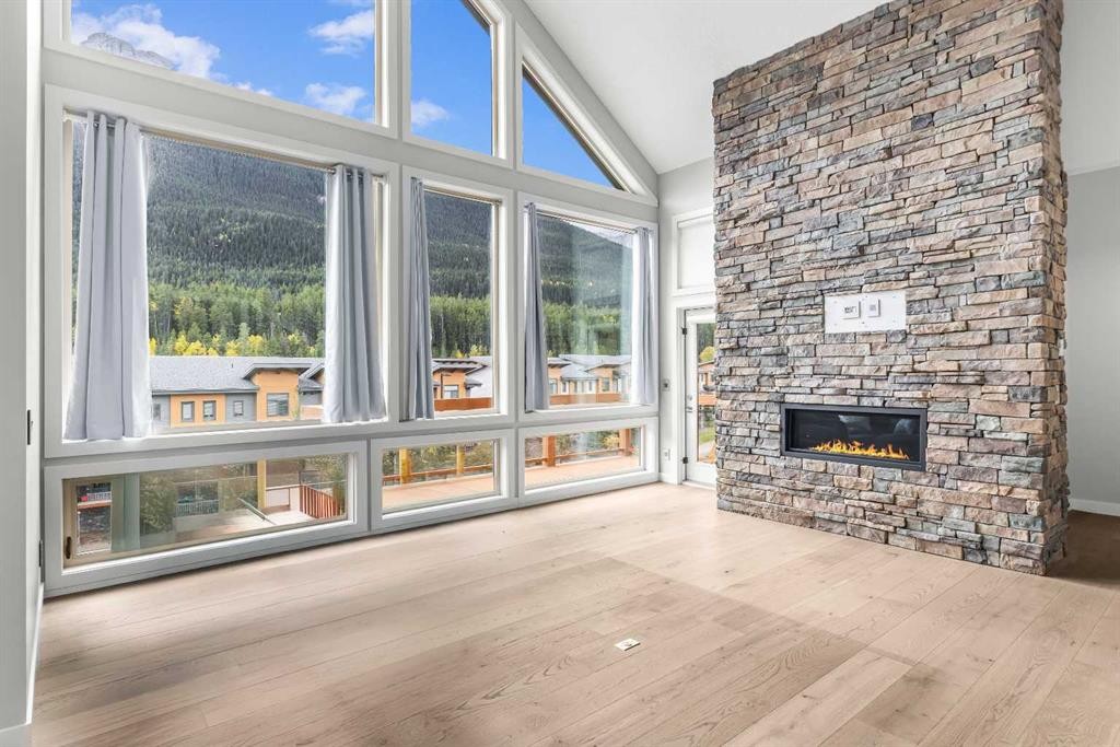 204-105 Stewart Creek Rise Sw, Canmore, AB - Indoor Photo Showing Other Room With Fireplace