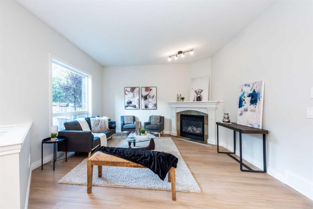181 Chapala Drive Se, Calgary, AB - Indoor Photo Showing Living Room With Fireplace