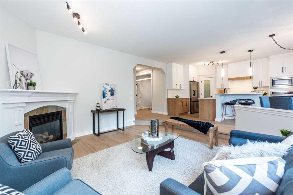 181 Chapala Drive Se, Calgary, AB - Indoor Photo Showing Living Room With Fireplace