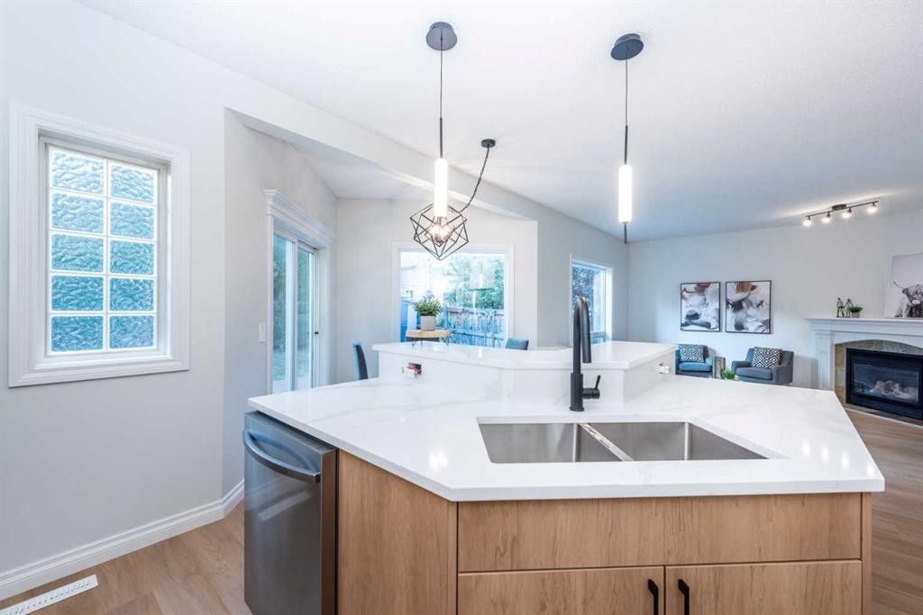 181 Chapala Drive Se, Calgary, AB - Indoor Photo Showing Kitchen With Fireplace