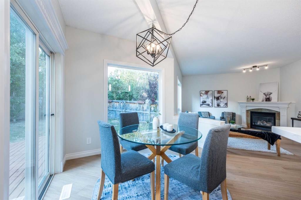 181 Chapala Drive Se, Calgary, AB - Indoor Photo Showing Dining Room With Fireplace