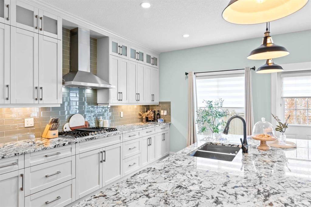 148 Baysprings Court Sw, Airdrie, AB - Indoor Photo Showing Kitchen With Double Sink With Upgraded Kitchen