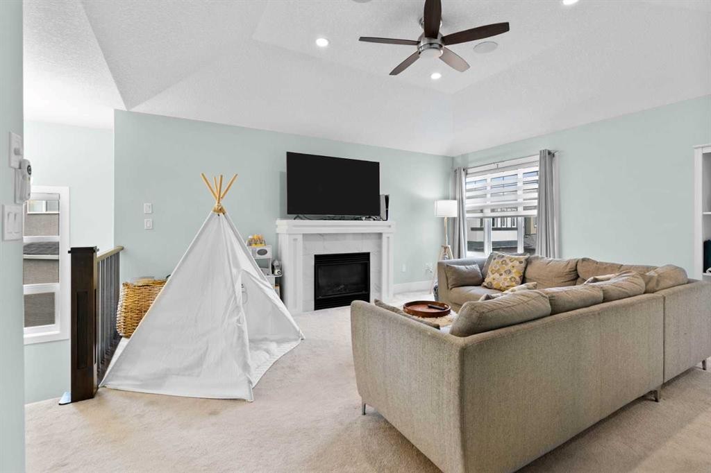148 Baysprings Court Sw, Airdrie, AB - Indoor Photo Showing Living Room With Fireplace