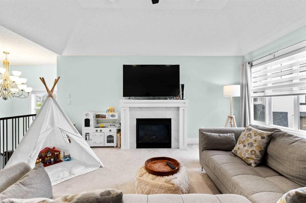 148 Baysprings Court Sw, Airdrie, AB - Indoor Photo Showing Living Room With Fireplace