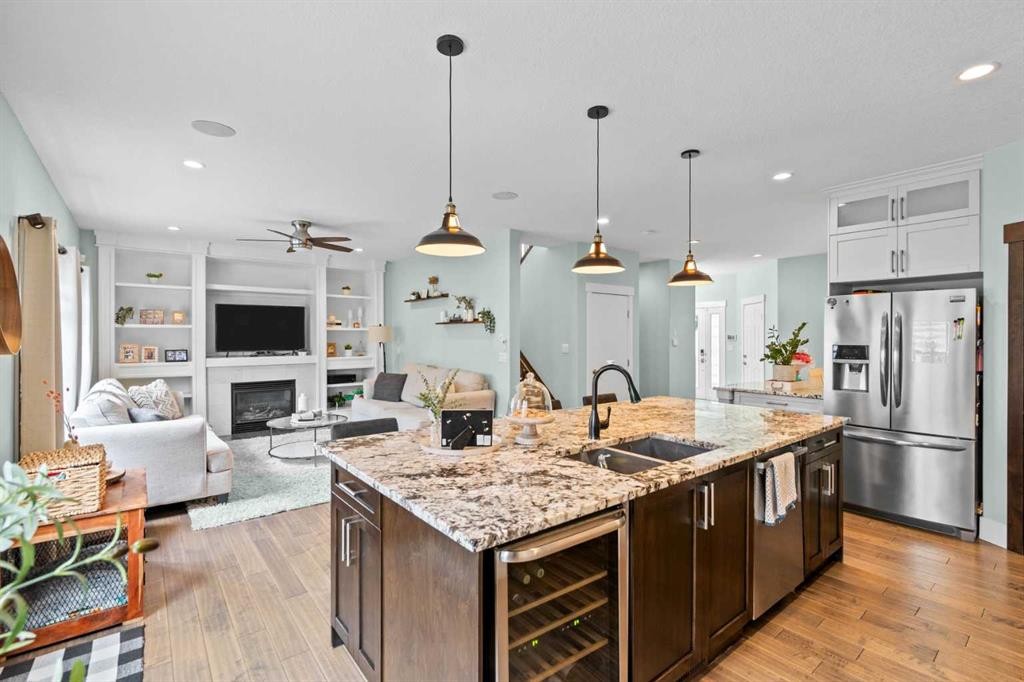 148 Baysprings Court Sw, Airdrie, AB - Indoor Photo Showing Kitchen With Fireplace With Double Sink With Upgraded Kitchen