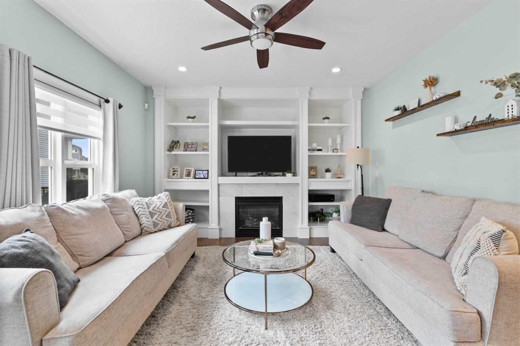 148 Baysprings Court Sw, Airdrie, AB - Indoor Photo Showing Living Room With Fireplace