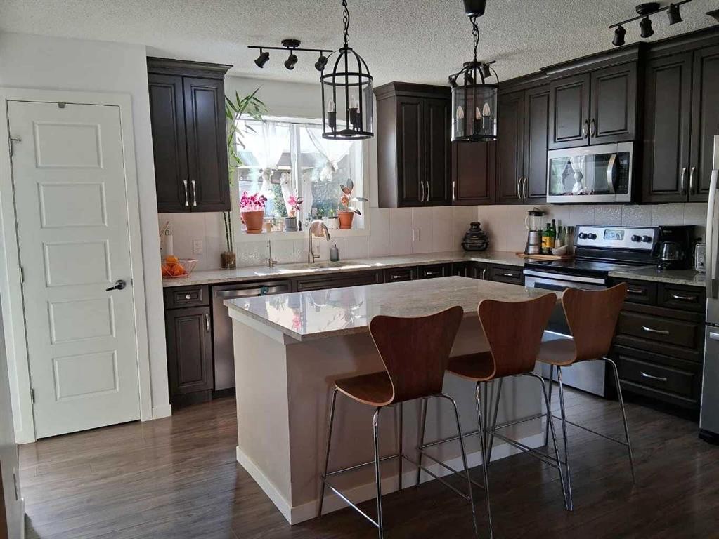 49 Fireside Bend, Cochrane, AB - Indoor Photo Showing Kitchen With Upgraded Kitchen