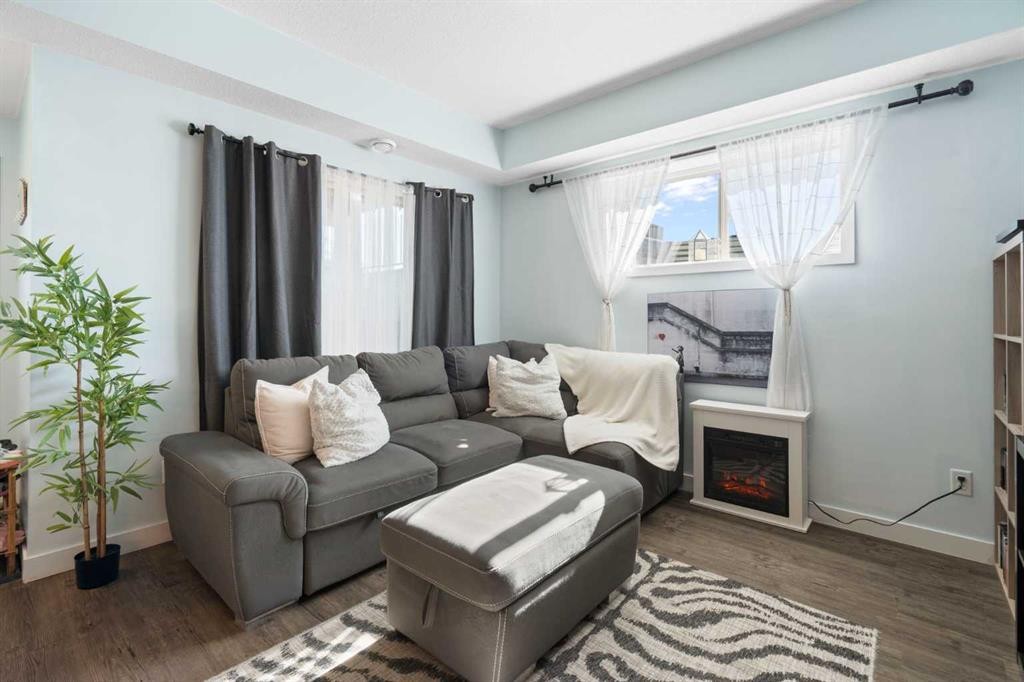 1104-2461 Baysprings Link Sw, Airdrie, AB - Indoor Photo Showing Living Room With Fireplace