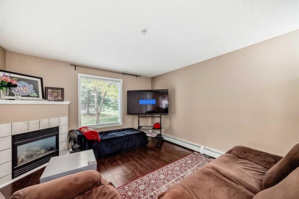 119-6000 Somervale Court Sw, Calgary, AB - Indoor Photo Showing Living Room With Fireplace