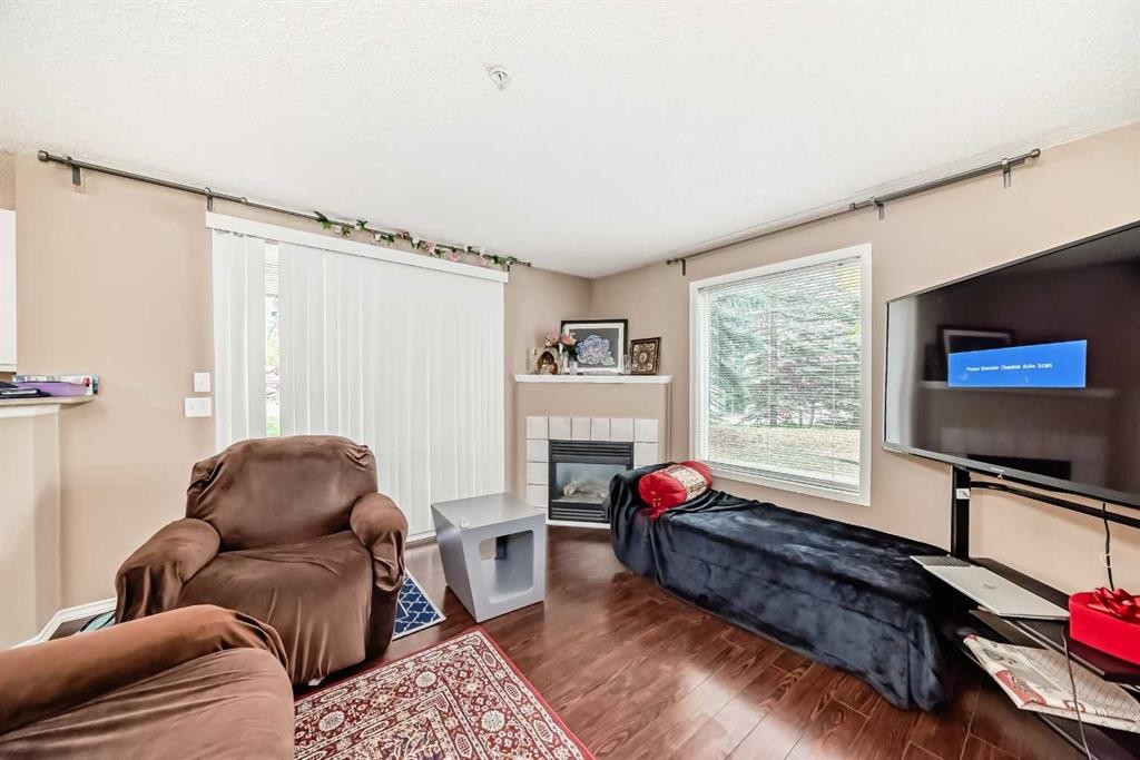 119-6000 Somervale Court Sw, Calgary, AB - Indoor Photo Showing Living Room With Fireplace