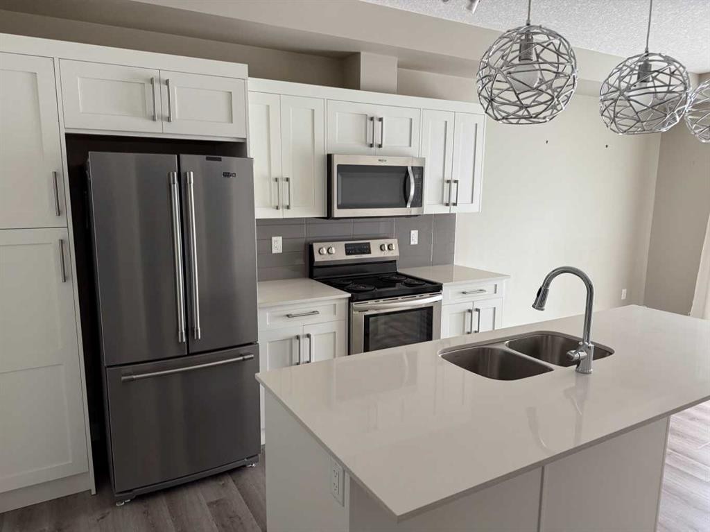 203-100 Auburn Meadows Common Se, Calgary, AB - Indoor Photo Showing Kitchen With Stainless Steel Kitchen With Double Sink With Upgraded Kitchen