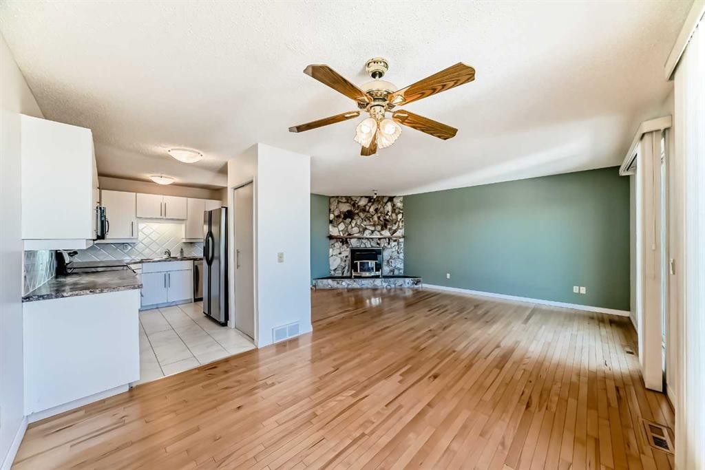 40 Glenpatrick Crescent, Cochrane, AB - Indoor Photo Showing Kitchen With Fireplace