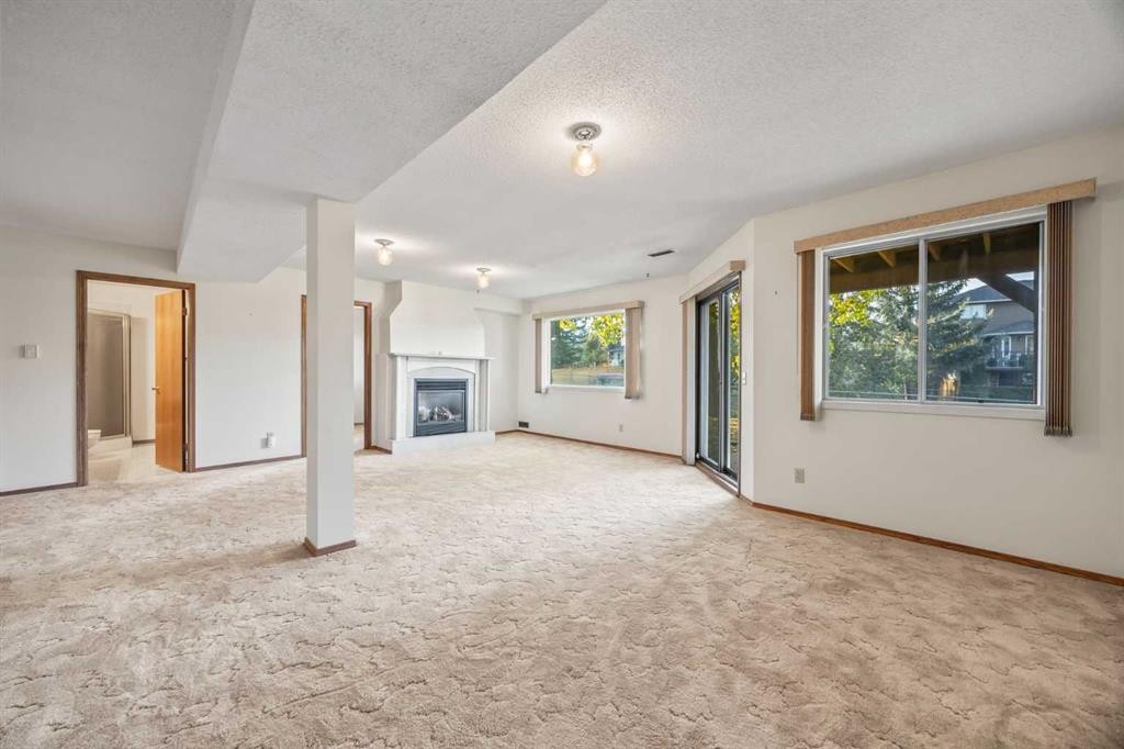52 Sandarac Circle Nw, Calgary, AB - Indoor Photo Showing Other Room With Fireplace