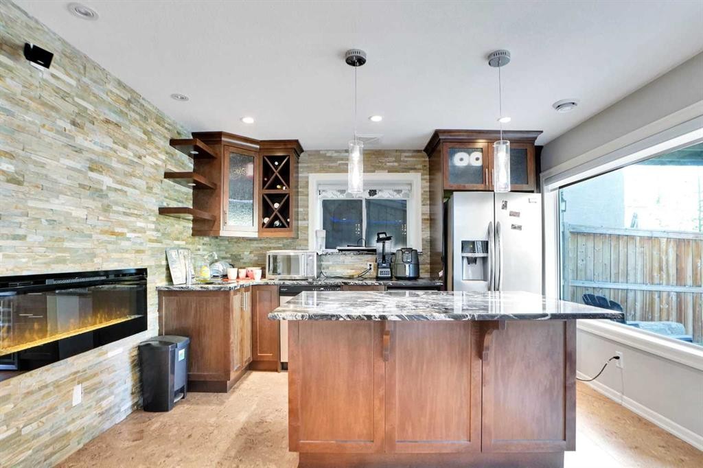 60 Cranarch Rise Se, Calgary, AB - Indoor Photo Showing Kitchen With Fireplace With Upgraded Kitchen