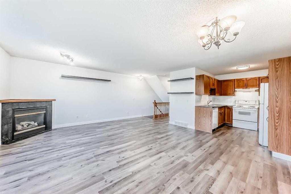 184 Mt Aberdeen Manor Se, Calgary, AB - Indoor Photo Showing Kitchen With Fireplace