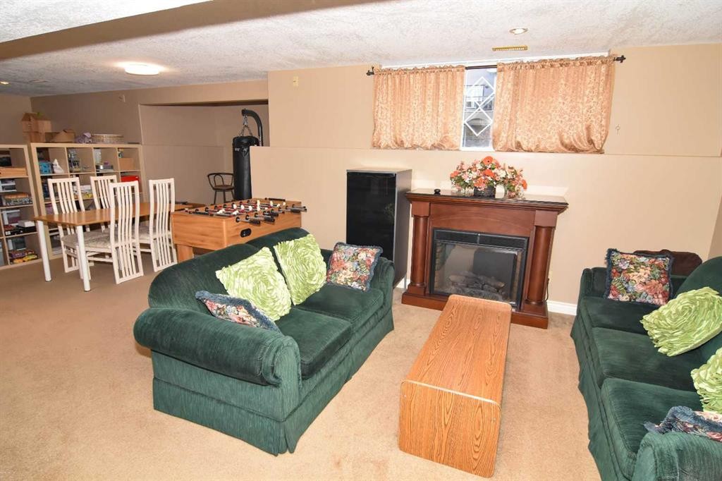 107 Panatella Close Nw, Calgary, AB - Indoor Photo Showing Living Room With Fireplace
