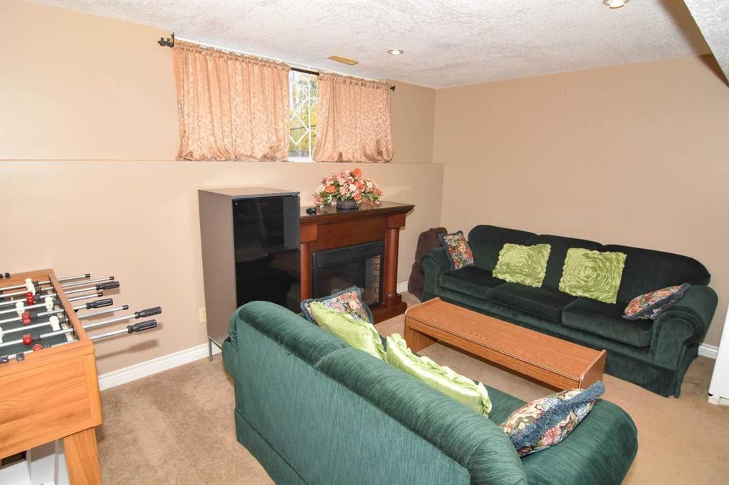 107 Panatella Close Nw, Calgary, AB - Indoor Photo Showing Living Room With Fireplace