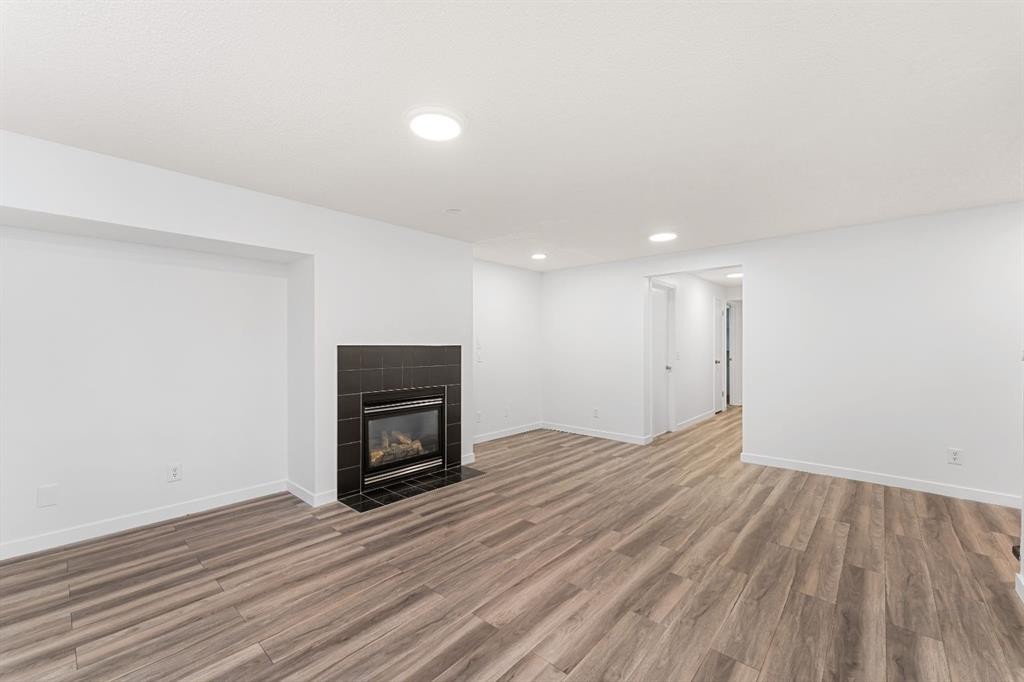 203 Prestwick Heights Se, Calgary, AB - Indoor Photo Showing Living Room With Fireplace