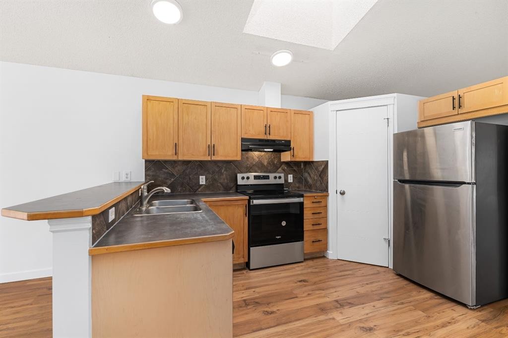 203 Prestwick Heights Se, Calgary, AB - Indoor Photo Showing Kitchen With Double Sink