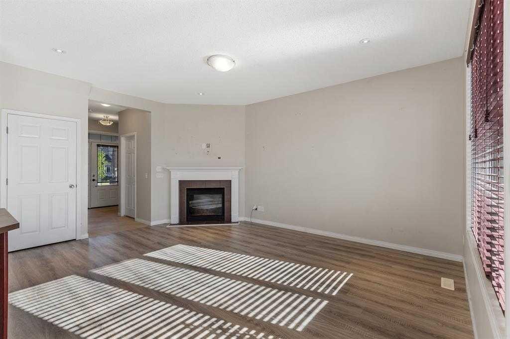 724 Windridge Road Sw, Airdrie, AB - Indoor Photo Showing Living Room With Fireplace