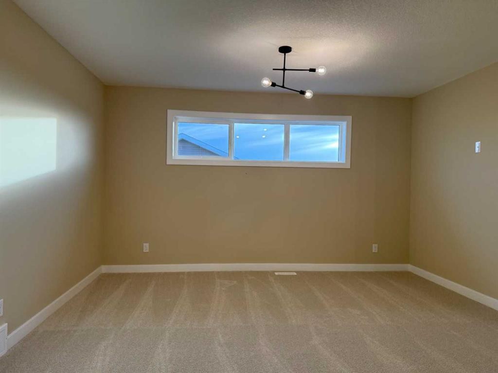 72 Sunrise Heath, Cochrane, AB - Indoor Photo Showing Other Room