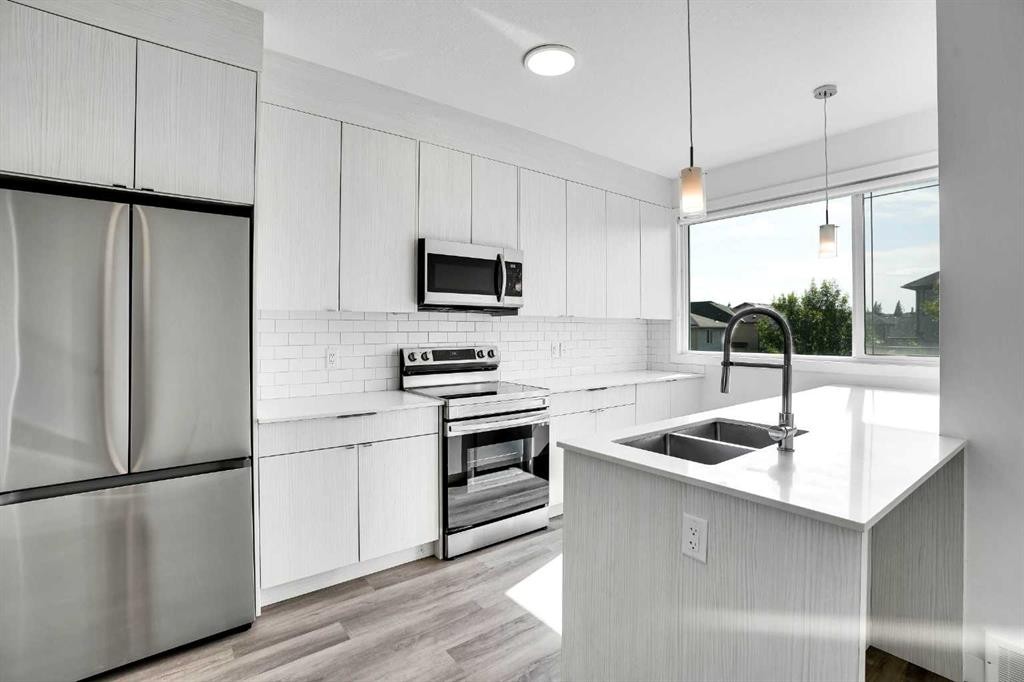 105 Panatella Square Nw, Calgary, AB - Indoor Photo Showing Kitchen With Stainless Steel Kitchen With Double Sink With Upgraded Kitchen