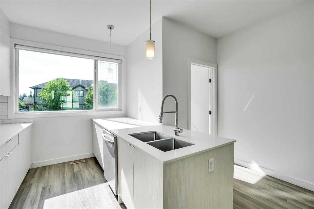 105 Panatella Square Nw, Calgary, AB - Indoor Photo Showing Kitchen With Double Sink