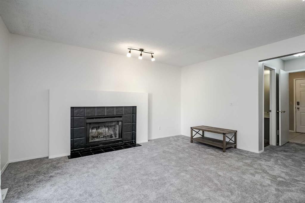 8 Millbank Road Sw, Calgary, AB - Indoor Photo Showing Living Room With Fireplace