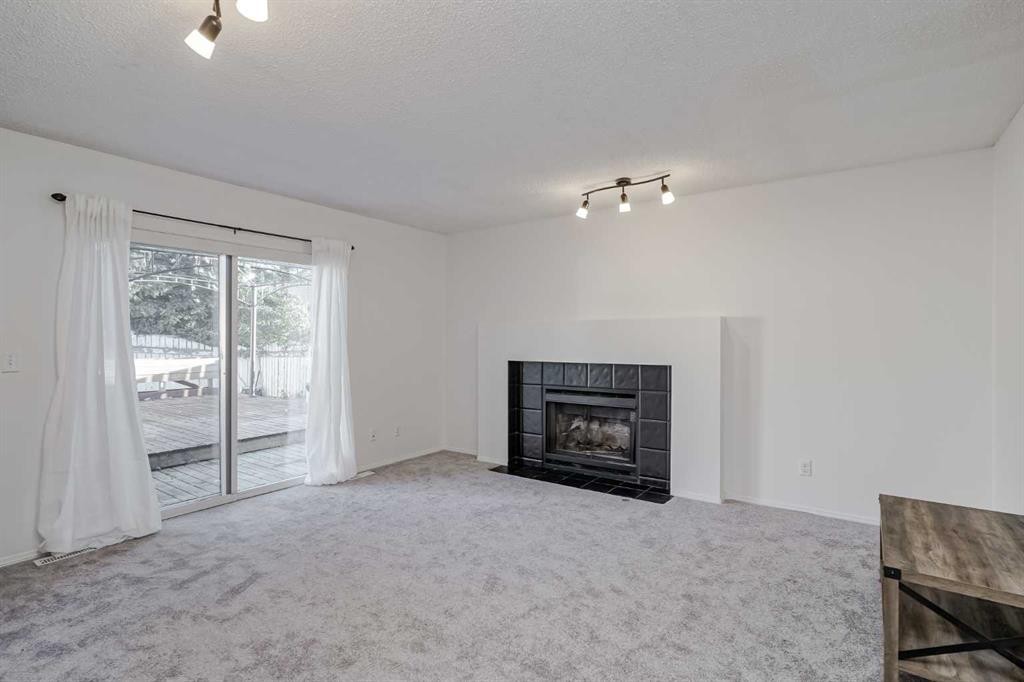 8 Millbank Road Sw, Calgary, AB - Indoor Photo Showing Living Room With Fireplace