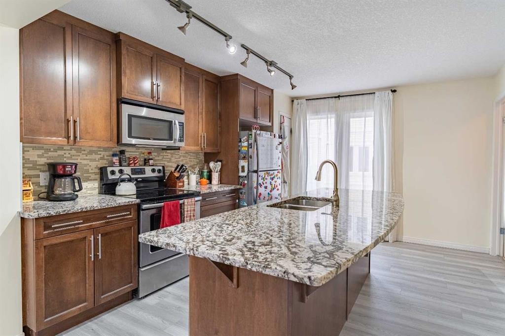 37 Auburn Bay Link Se, Calgary, AB - Indoor Photo Showing Kitchen With Stainless Steel Kitchen With Double Sink With Upgraded Kitchen