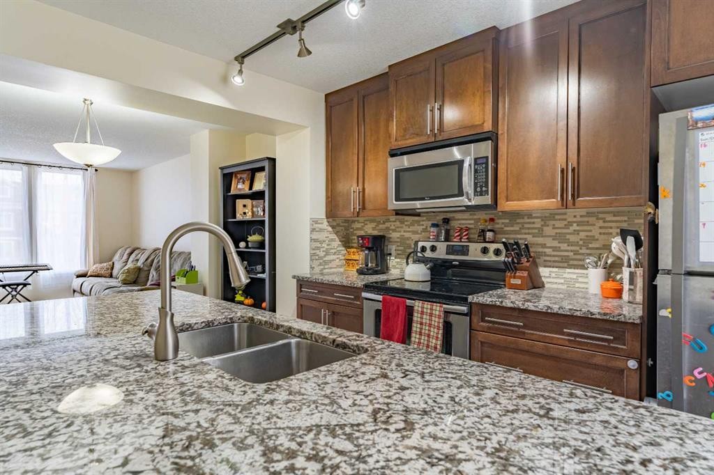37 Auburn Bay Link Se, Calgary, AB - Indoor Photo Showing Kitchen With Stainless Steel Kitchen With Double Sink With Upgraded Kitchen