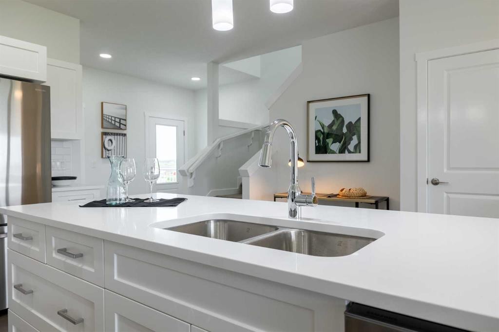 71 Heritage Manor, Cochrane, AB - Indoor Photo Showing Kitchen With Double Sink