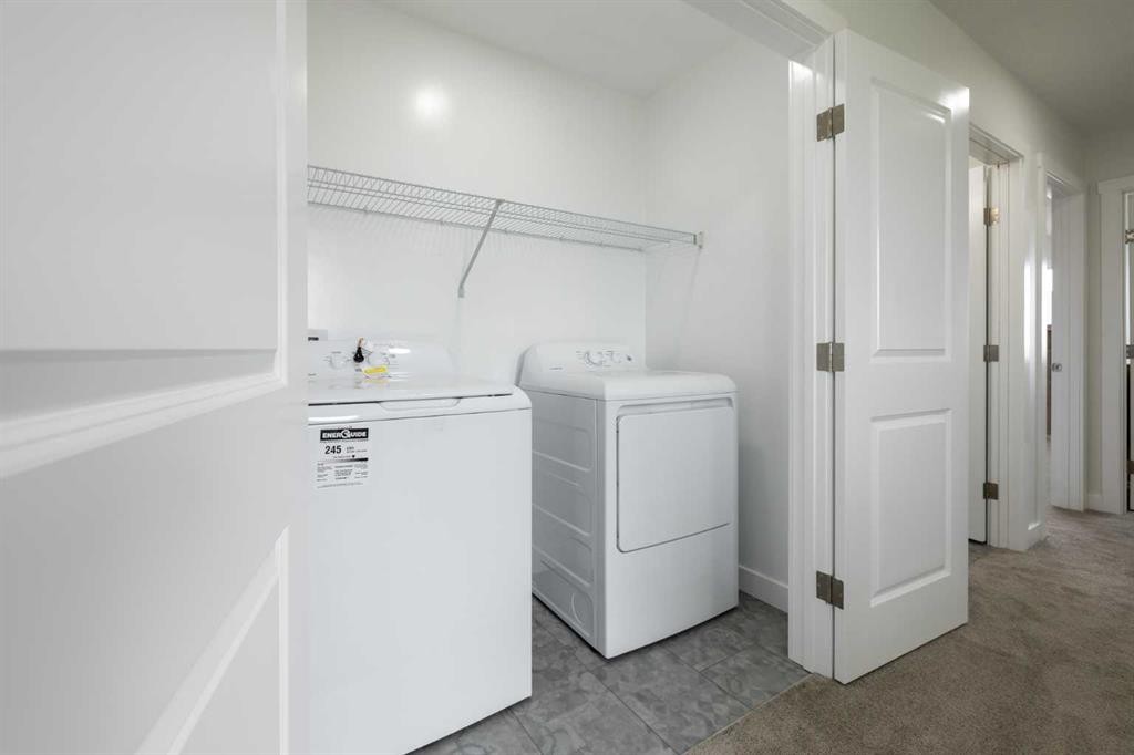 71 Heritage Manor, Cochrane, AB - Indoor Photo Showing Laundry Room