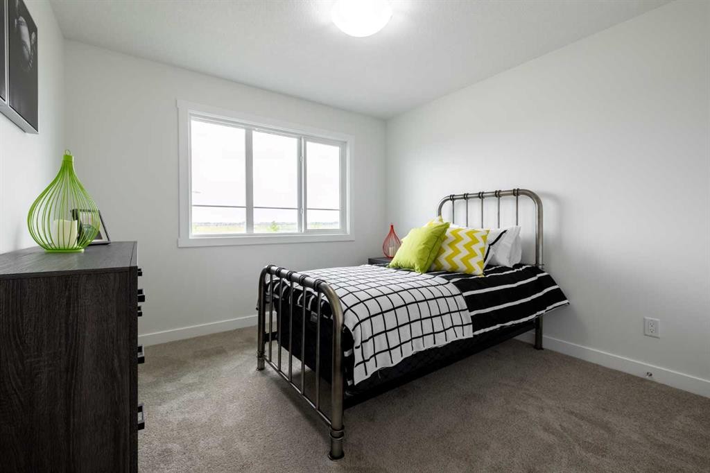 71 Heritage Manor, Cochrane, AB - Indoor Photo Showing Bedroom