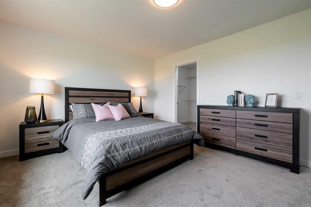 71 Heritage Manor, Cochrane, AB - Indoor Photo Showing Bedroom
