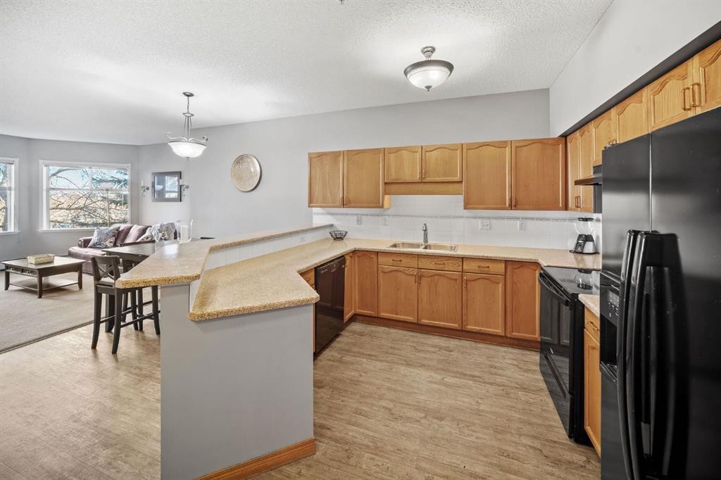 207-200 Lincoln Way Sw, Calgary, AB - Indoor Photo Showing Kitchen With Double Sink