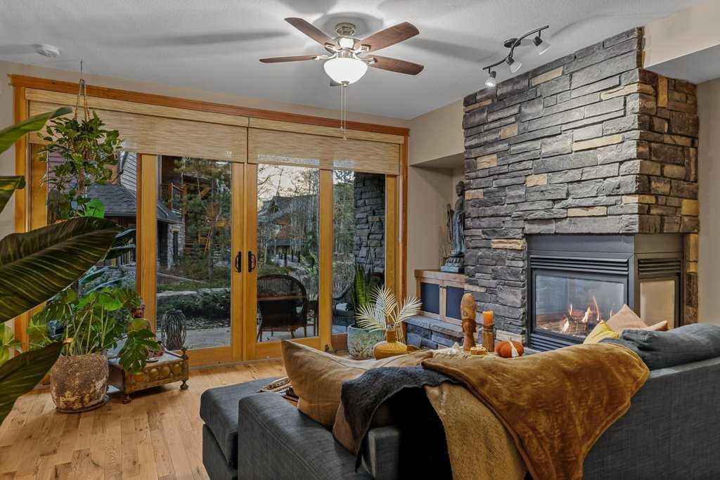2107-101B Stewart Creek Landing, Canmore, AB - Indoor Photo Showing Living Room With Fireplace