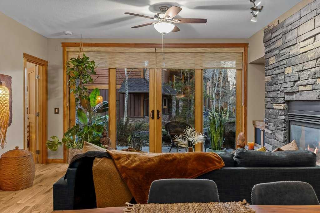 2107-101B Stewart Creek Landing, Canmore, AB - Indoor Photo Showing Living Room With Fireplace