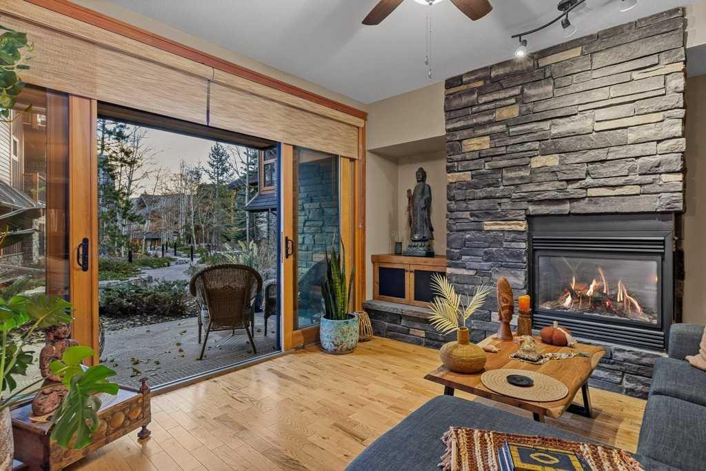 2107-101B Stewart Creek Landing, Canmore, AB - Indoor Photo Showing Living Room With Fireplace