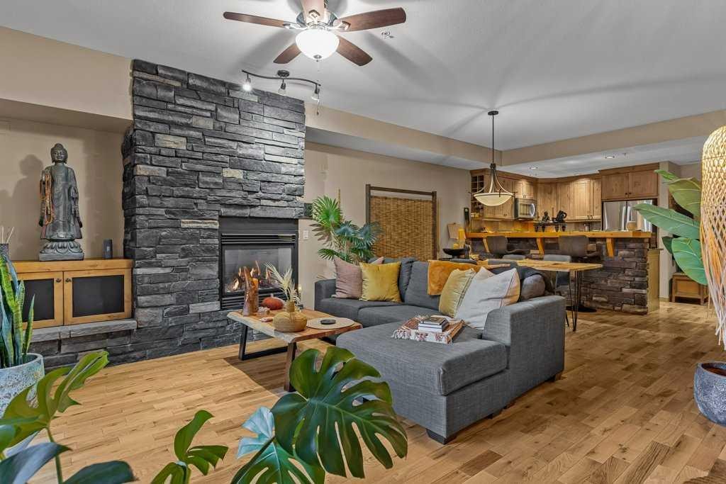 2107-101B Stewart Creek Landing, Canmore, AB - Indoor Photo Showing Living Room With Fireplace