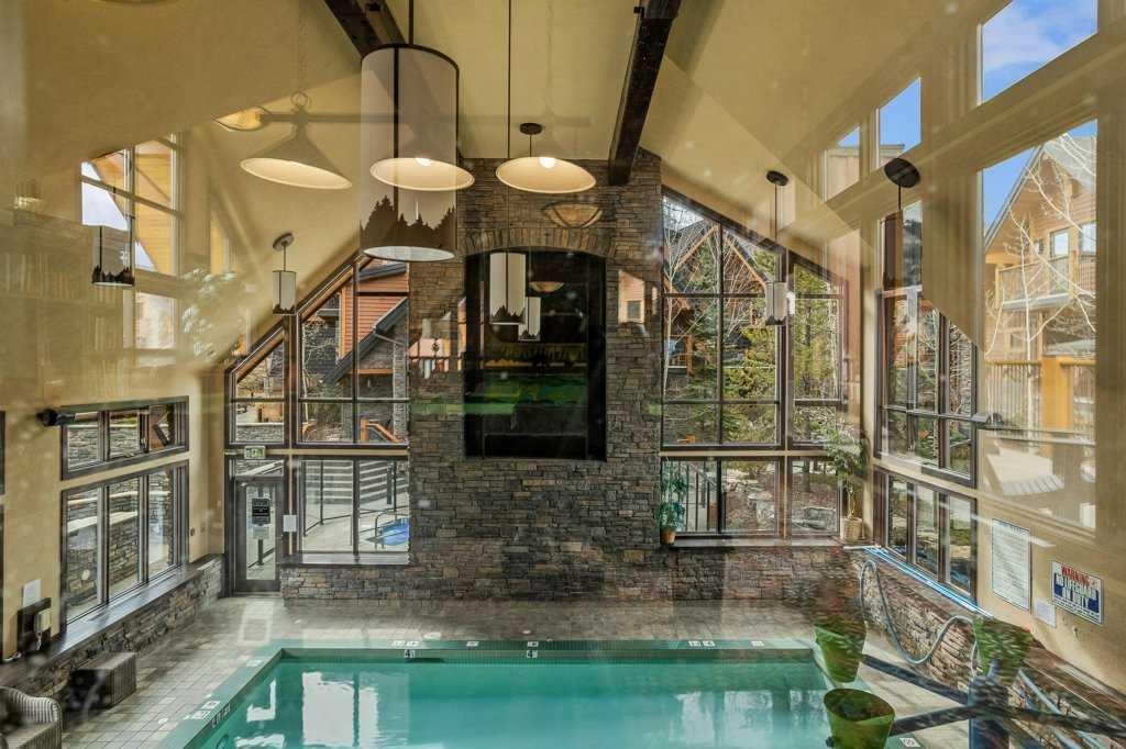 2107-101B Stewart Creek Landing, Canmore, AB - Indoor Photo Showing Other Room With In Ground Pool