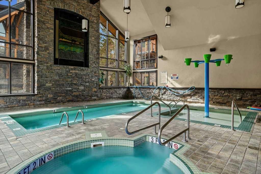 2107-101B Stewart Creek Landing, Canmore, AB - With In Ground Pool